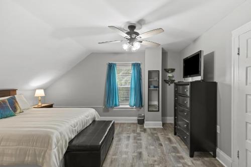 a bedroom with a bed and a ceiling fan at Spacious Cottage near Airport, Hospitals, and Highways in Bel-Ridge