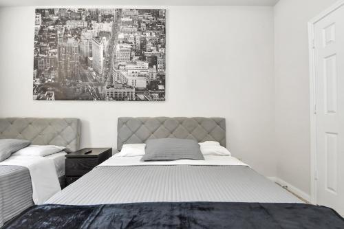 a bedroom with two beds and a painting on the wall at Cozy 3-Bd Haven Close to Med Center & Downtown HTX in Houston