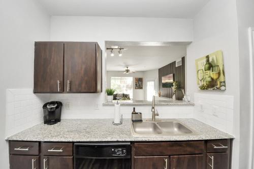 a kitchen with a sink and a counter at Cozy 3-Bd Haven Close to Med Center & Downtown HTX in Houston
