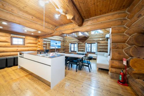 a kitchen and dining room in a log cabin at Terrace Niseko Glide in Kutchan