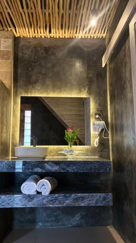 a bathroom with a sink and a mirror at CARROLINE homestay ricefield in Kapal