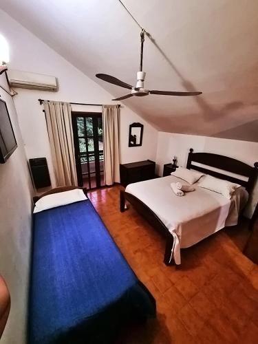 a bedroom with a bed and a blue carpet at Cabañas Lorelei in Villa General Belgrano