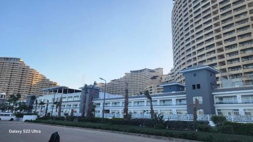 a building in a city with tall buildings at Pyramids Porto Sokhna Hotel Apartments in Ain Sokhna
