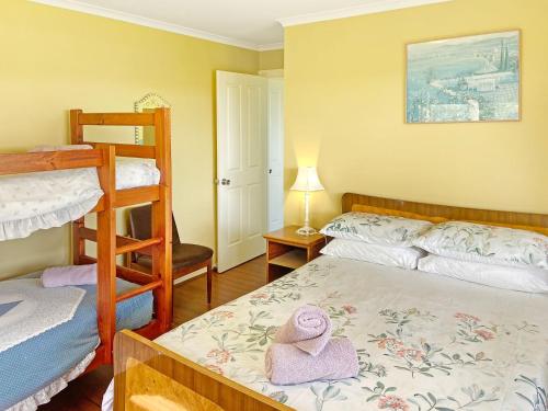 a bedroom with a bed with a stuffed animal on it at 158 Wallaga Lake in Bermagui