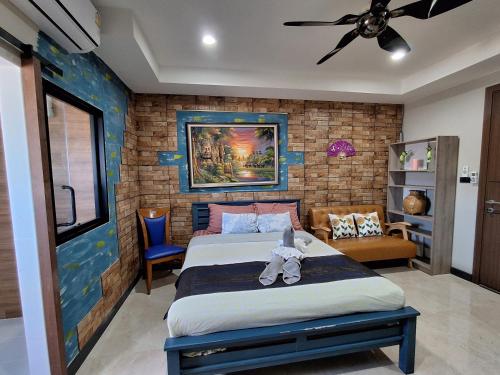 a bedroom with a bed with a teddy bear on it at Turtle Nest in Hua Hin
