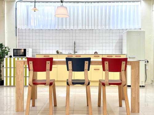a kitchen with a wooden table and two chairs at The FLOW HOUSE in Suwon