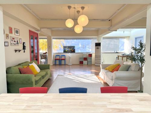a living room with two couches and a table at The FLOW HOUSE in Suwon
