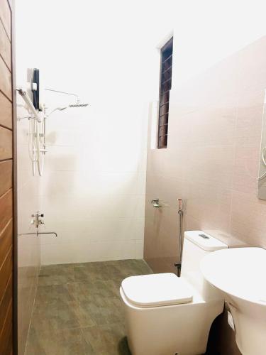 a bathroom with a toilet and a sink at The Pinnacle Life in Matale