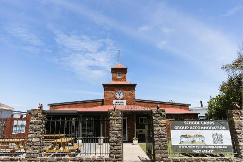 a brick building with a clock tower on top of it at Warra Gnan Coastal Camp in Warrnambool