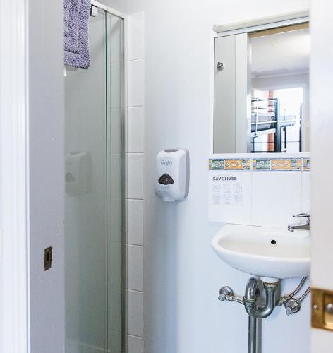 a bathroom with a sink and a mirror at Warra Gnan Coastal Camp in Warrnambool