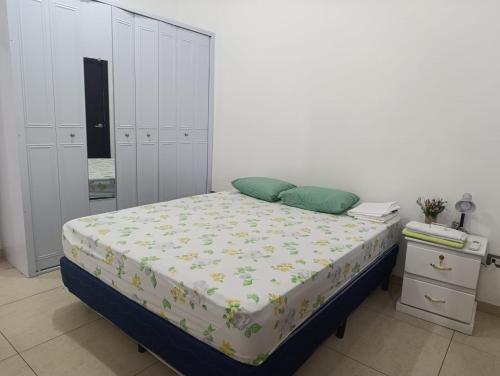 a bedroom with a bed and a white wall at Beautiful and cozy home with Rent a car available in San Salvador
