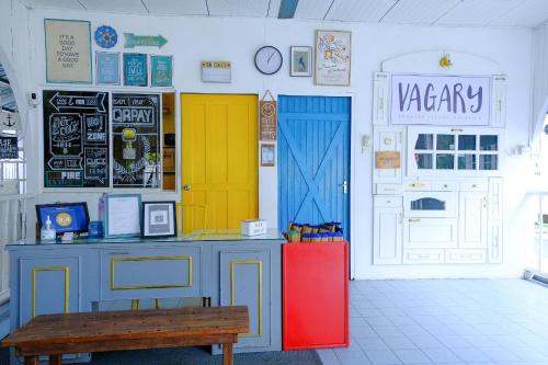 a restaurant with colorful doors and a bench in a room at Vagary Pangkor in Pangkor