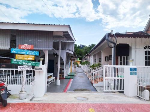 an empty street in a small town with buildings at Vagary Pangkor in Pangkor