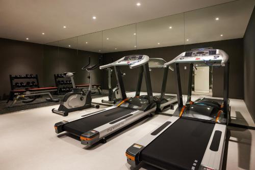 a gym with several treadmills in a room at Yeouido Park Hotel in Seoul