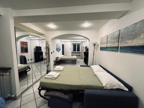 a bedroom with a bed and a living room at Parking available- Appartamento in centro storico a Genova in Genova