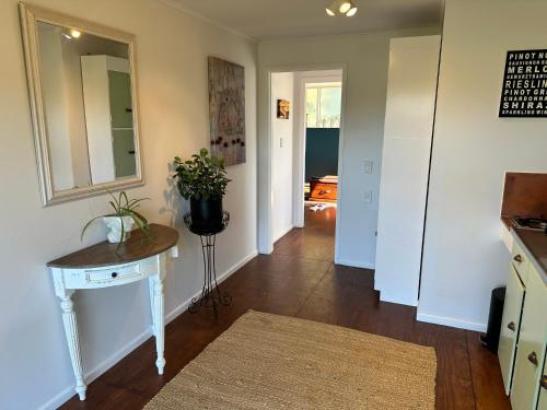 Dark Sky Cottage في غريتاون: مدخل منزل مع طاولة ومرآة