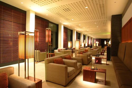 a hotel lobby with couches and tables and lamps at The Lalu Sun Moon Lake in Yuchi