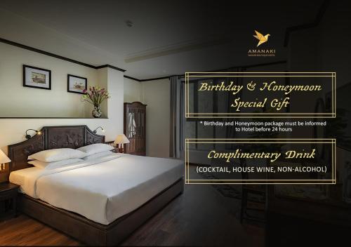 a room with a bed with a sign for a anniversary gift at Amanaki Saigon Boutique Hotel in Ho Chi Minh City