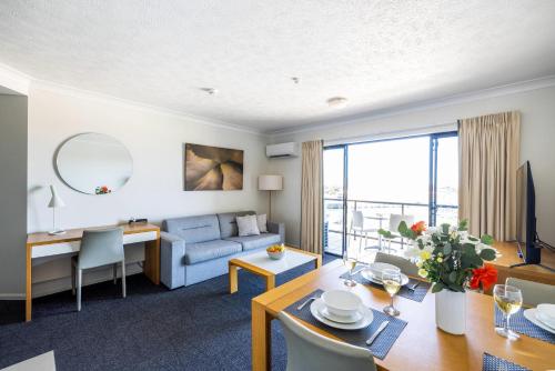 a living room with a couch and a table at MainStay Suites Townsville in Townsville