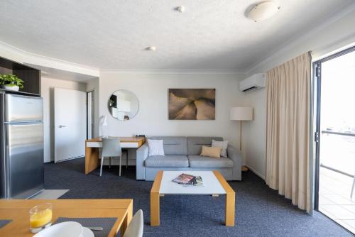 a living room with a couch and a table at MainStay Suites Townsville in Townsville