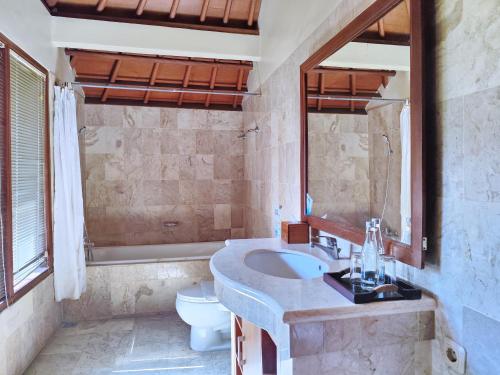 a bathroom with a sink and a toilet at Villa Diana Bali 14 Bedrooms in Seminyak