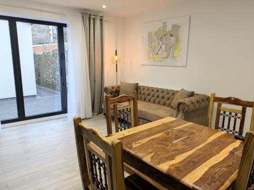 a living room with a table and a couch at 2 bedroom house with yard in Cardiff