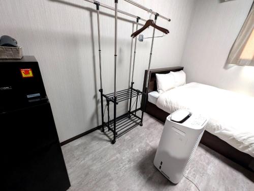 Postel nebo postele na pokoji v ubytování アミスタホテルアネックス