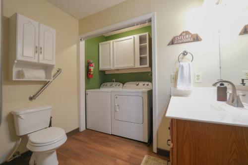 a small bathroom with a toilet and a sink at The Bearfoot Cabin! Ideally located, decorated for Christmas, Fireplace, Game Room! in Sevierville