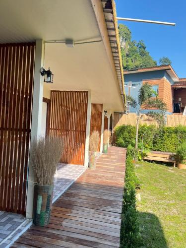 a house with a wooden porch with a fence at La Depa PP House in Phi Phi Islands