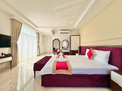 a hotel room with a large bed and a television at Phu Gia Hotel 13-15 Hoàng Quốc Việt in Ho Chi Minh City