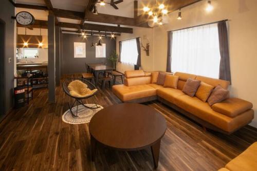 a living room with a couch and a table at Yadoya YADOKARI in Pippu
