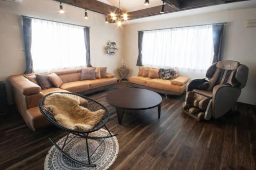 a living room with a couch and chairs and a table at Yadoya YADOKARI in Pippu