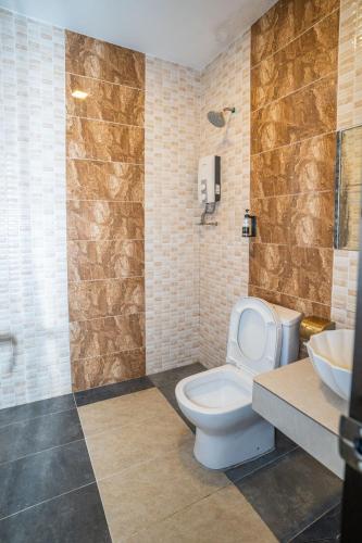 a bathroom with a toilet and a sink at De Grand Boutique Hotel in Sepang