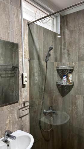 a bathroom with a shower and a sink at Kalyana Guest House in Bandung