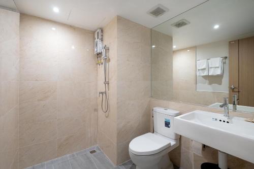 a bathroom with a toilet and a sink and a shower at P-Park Hotel Bangkok in Bangkok
