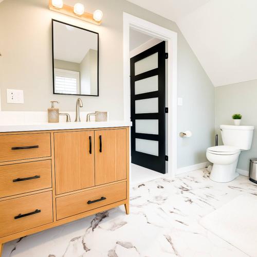 a bathroom with a sink and a toilet at Profs Riverside Haven Art & Style Sleeps 10 in South Bend