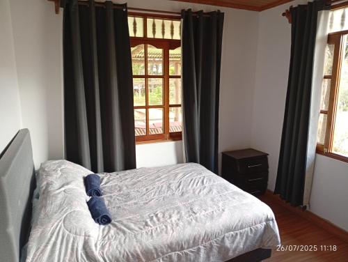 En eller flere senge i et værelse på Casa Las Palmeras