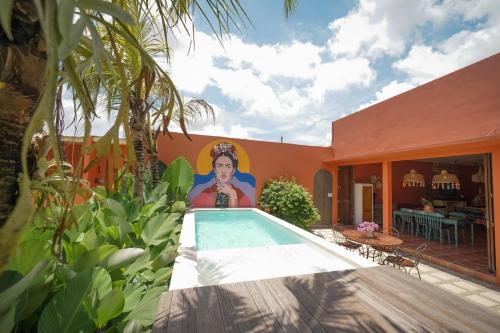a house with a swimming pool with a painting on the wall at Amador by Suasana Villa in Jarakan