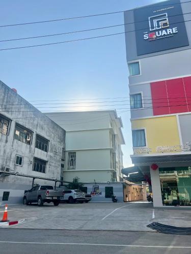 a parking lot in front of a building at The Square Hotel เดอะสแควร์โฮเทลนครพนม in Nakhon Phanom