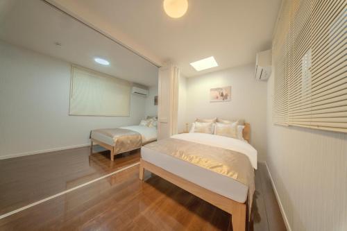 En eller flere senge i et værelse på Seiha 中川西