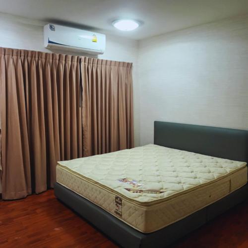 een slaapkamer met een bed in een kamer bij Leon Sukhumvit 62 in Bangkok