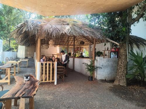 a group of people sitting at a bar in a restaurant at Arohha in Mandrem