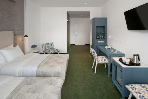 a hotel room with a bed and a desk at Hotel Metropol in Warsaw