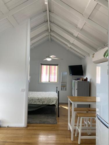 a bedroom with a bed and a table in a room at The Little House in Golden Square