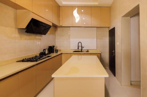 a kitchen with a sink and a stove in it at Mozabella Apartment in Karsana