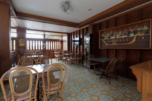 a dining room with tables and chairs in a restaurant at Baan U Sabai Boutique House-SHA Plus in Chiang Mai