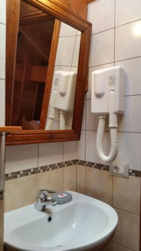 a bathroom with a sink and a mirror at Agriturismo Alagna in Alagna Valsesia