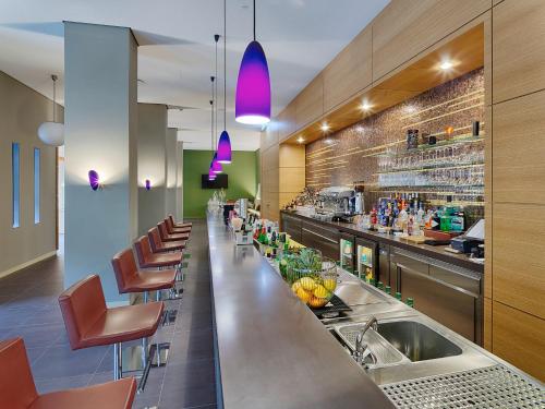 a bar in a restaurant with a sink and chairs at Hotel Elbresidenz an der Therme in Bad Schandau