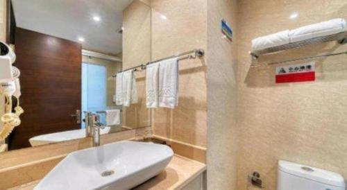 Hangzhou Wangzhou Boutique Hotel في Yuhang: حمام مع حوض ومرحاض