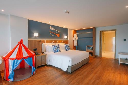 a bedroom with a bed with a tent on it at Ocean Marina Resort Pattaya Jomtien in Na Jomtien